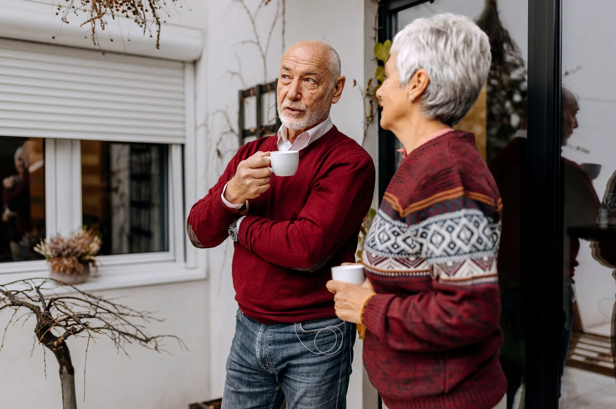 a man holding a cup and a woman holding a cup